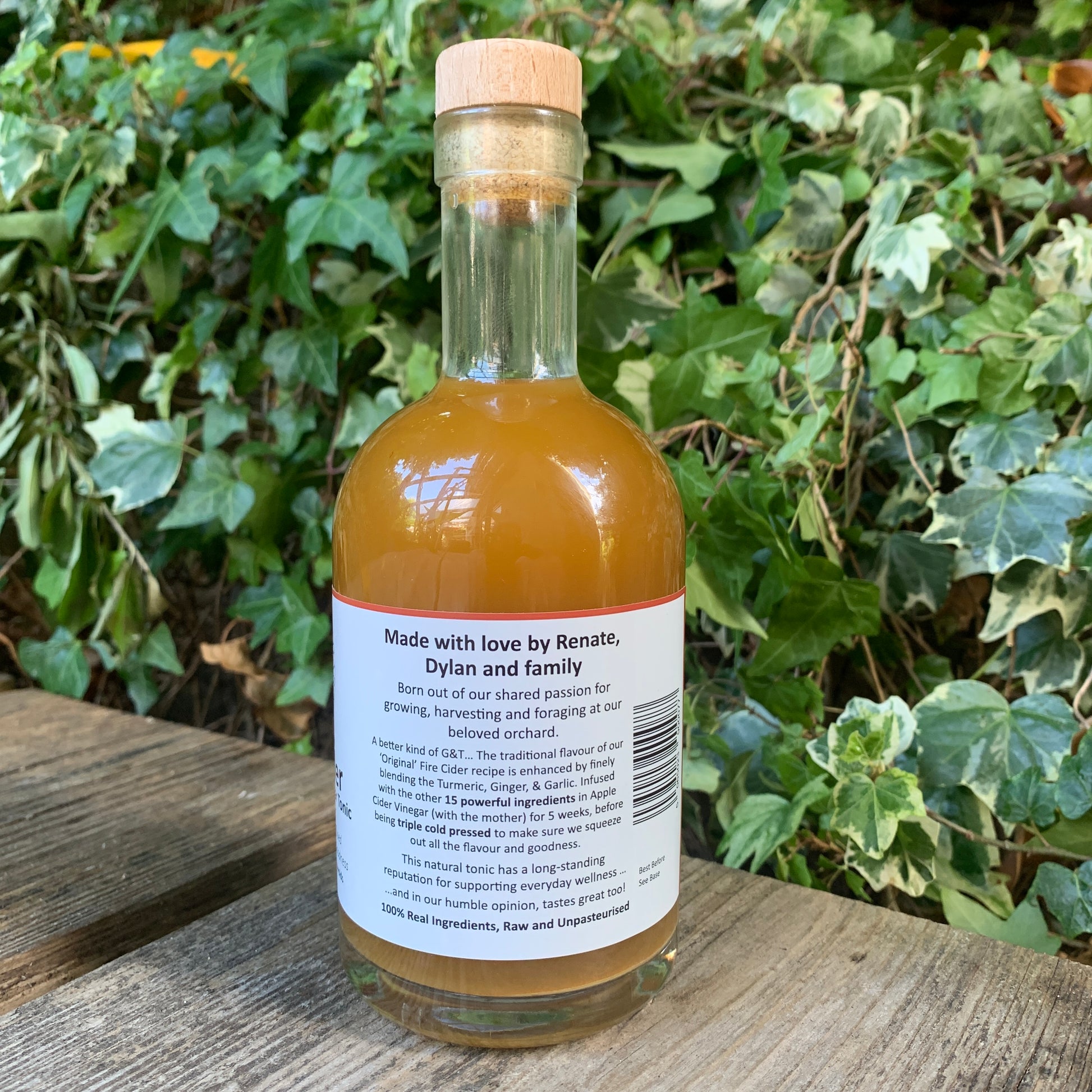 Back label of G&T Boost Fire Cider 350ml – handcrafted apple cider vinegar tonic made by Renate, Dylan and family, captured in natural garden setting with green ivy