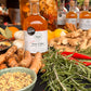 Fire cider bottles with ingredients on a table