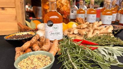 Fire cider bottles with ingredients on a table